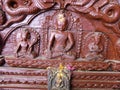 Buddha images on a wooden door inside Hiranya Varna Mahavihar. golden temple Patan, Kathmandu. Nepal
