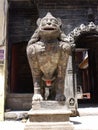 Stone male lion at the entrance gate of Hiranya Varna Mahavihar. Golden temple. Patan, Kathmandu. Nepal