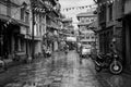 People Driving in the Rain in Kathmandu Patan Durbar Marg