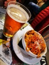 Patatas bravas, fried potatoes with spicy sauce, typical Spanish tapa and a glass of beer