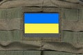 Patch on an adhesive tape with the Ukrainian flag on a military uniform, backpack, bag. Ukrainian flag attached to