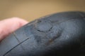 A patch glued to a tyre tubing to repair a puncture