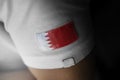 Patch of the national flag of the Bahrain on a white t-shirt