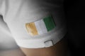 Patch of the national flag of the Cote dIvoire on a white t-shirt