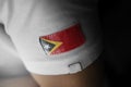 Patch of the national flag of the East Timor on a white t-shirt