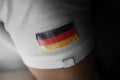 Patch of the national flag of the Germany on a white t-shirt Royalty Free Stock Photo