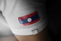 Patch of the national flag of the Laos on a white t-shirt