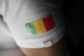 Patch of the national flag of the Mali on a white t-shirt