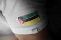 Patch of the national flag of the Mozambique on a white t-shirt