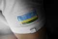 Patch of the national flag of the Rwanda on a white t-shirt