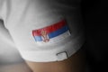 Patch of the national flag of the Serbia on a white t-shirt Royalty Free Stock Photo