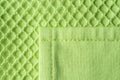 Patch pocket on green mesh cotton jersey macro. Texture of light green knitted fabric with mesh for modern sportswear. Casual Royalty Free Stock Photo