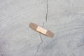 a patch is stuck on a crack in a concrete wall. Unscrupulous repair concept