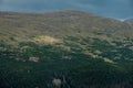 Patch of Sunlight Breaks Through The Clouds to Light The Hills Side