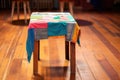 patched jeans with colorful fabric on wooden table