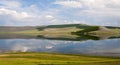 Forested hillsides reflected in placid lake