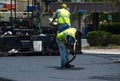 Patching road with hot asphalt