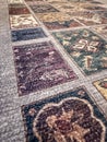 Patchwork carpet pattern with varied floral designs in a textured background Royalty Free Stock Photo