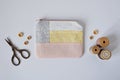 Patchwork mini pouch, wooden buttons, vintage thread spools and retro scissors Royalty Free Stock Photo