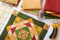 Patchwork orange-green block, quilting fabrics, sewing accessories Royalty Free Stock Photo