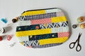 Patchwork quilted makeup bag with wooden beads, thread, metal thimble, retro scissors and clips