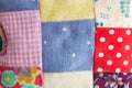 Patchwork, sewing, tailoring and fashion concept - macro on beautiful quilted cushion, cute pillow from different flaps