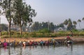 Women do laundry in canal water, Patel Nagar, Karnataka, India