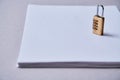 Patent , copyright or Intellectual protection concept: lock standing on a pack of sheets of paper with the inscription.