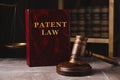 Patent Law book and gavel on grey marble table