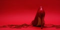 patent leather shiny female red stilettos and beads on a red background Royalty Free Stock Photo