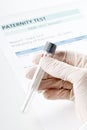 Paternity test result form with doctor holding buccal swab in te Royalty Free Stock Photo