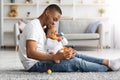 Paternity Time. Loving Young African-American Father Playing With Infant Baby At Home Royalty Free Stock Photo