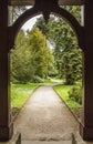 Path through arch leading to formal gardens