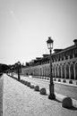 Path around the palatial building with a streetlight in foreground.