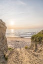 Path at Baltic sea over sand dunes with ocean view, sunset summer evening Royalty Free Stock Photo