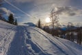 Path beaten in the snow with larches that stand out in the sky