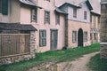 A path blurred by the rains between the houses in the retro style of the cityscape