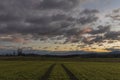 Path in color sunrise on green field near Vyhen village in south Bohemia