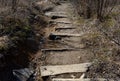 Path in the countryside staircase made of wooden beams and branches fixed to the ground using metal nails. gate of rebuttal of sta