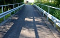 Path for cyclists with an asphalt surface. galvanized iron railing over road barriers. Bridge railing with tilting to the sides. r