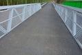 Path for cyclists with an asphalt surface. galvanized iron railing over road barriers. Bridge railing with tilting to the sides. r Royalty Free Stock Photo