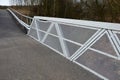 Path for cyclists with an asphalt surface. galvanized iron railing over road barriers. Bridge railing with tilting to the sides. r Royalty Free Stock Photo