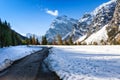 Path through early winter mountain landscape. Snow fall in the late autumn season