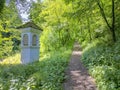 Path in the forest to the pilgrimage Church Maria Strassengel, a 14th century Gothic church situated on top of a hill in Judendorf Royalty Free Stock Photo