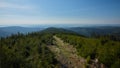 Path on forested mountain ridge with hazed valley in the background, Jeseniky, Czech Republic