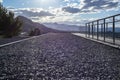 Path of gravel stones with metal handrails stretching into the distant mountains