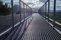 Path of gravel stones with metal handrails stretching into the distant mountains