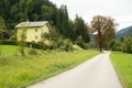 Path Through Green Meadow with Forest in the Background and Beautiful House Royalty Free Stock Photo