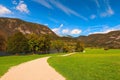 Path for hiking around picturesque Bohinj Lake in sunny autumn day. Beautiful nature landscape of lake and mountain range Royalty Free Stock Photo