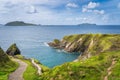 Path leading down to Dunquin Pier surrounded by turquoise water and tall cliffs, Dingle